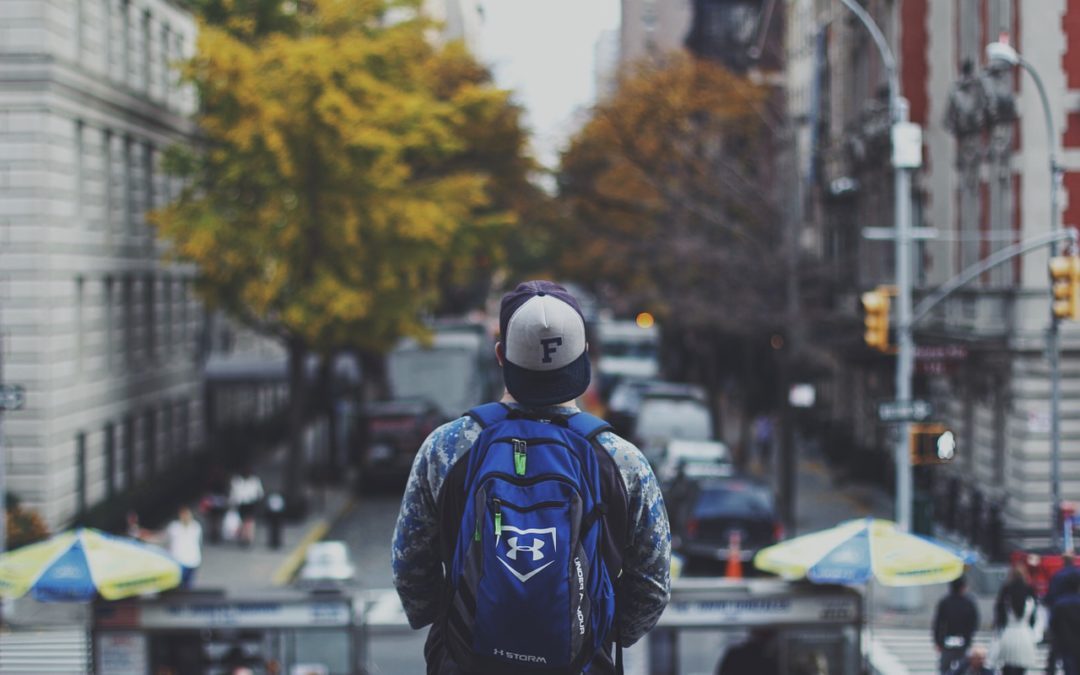 guy walking with backpack